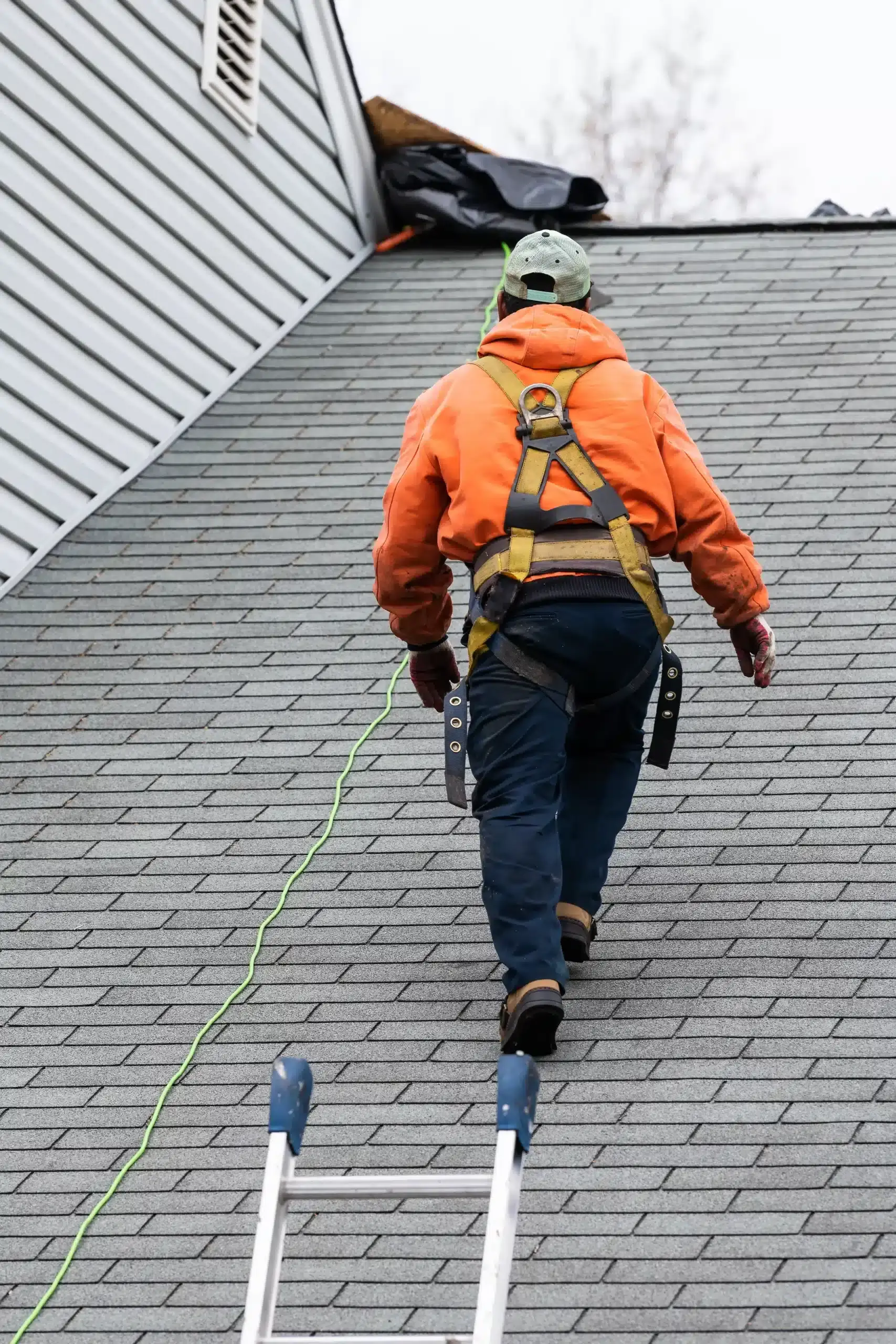 A professional walks on the roof after repairing the damaged roof in Dallas County, IA.